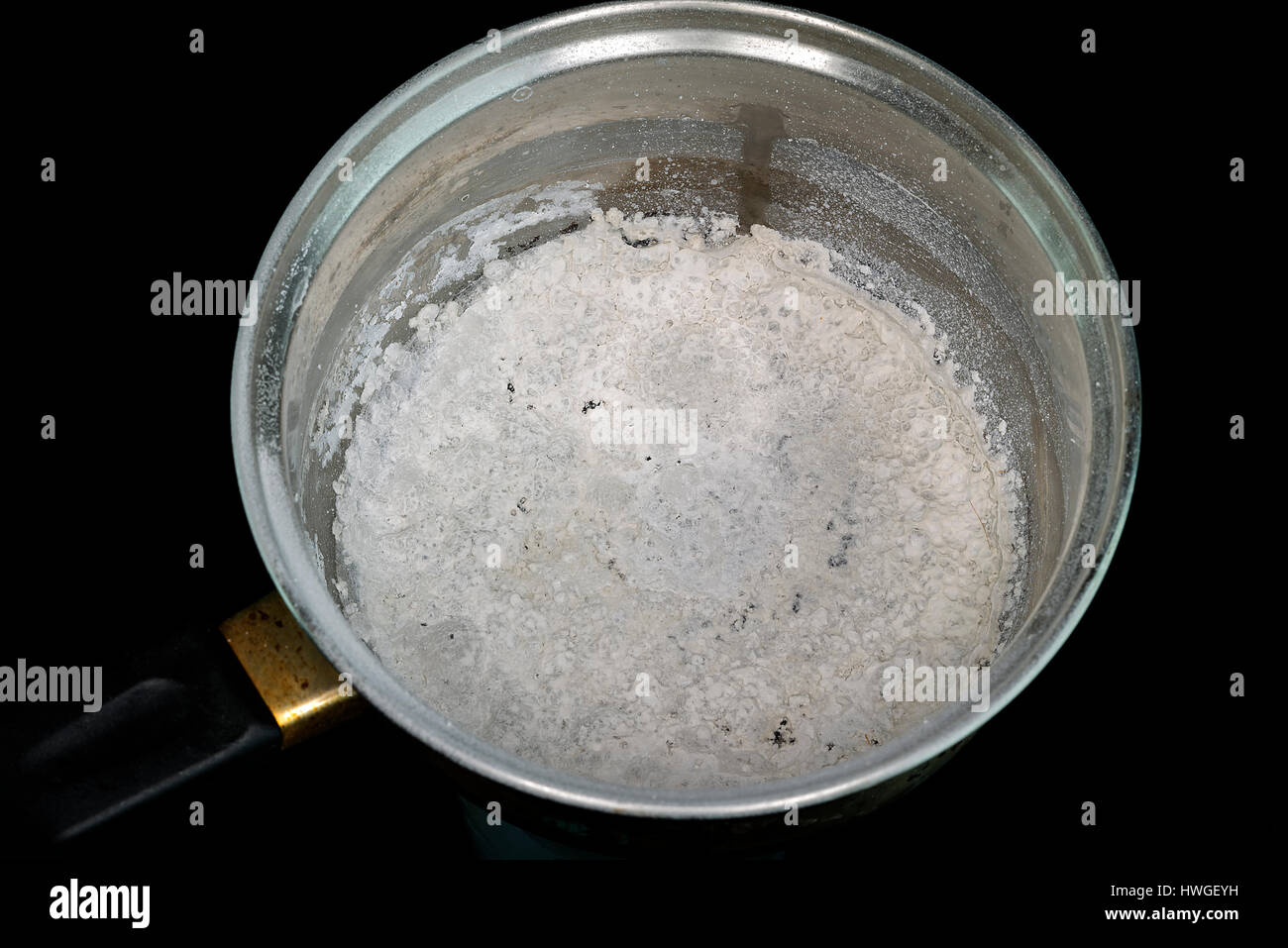 Pan with burnt food on black background Stock Photo Alamy