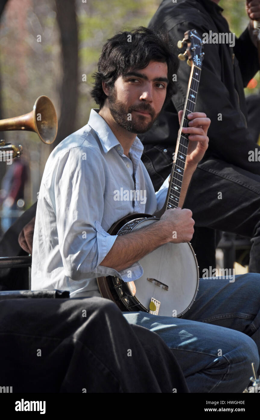 New York, USA - April 09, 2008: A musician plays his banjo in a trad. jazz band for the lunch time crowds in Washington Square, Greenwich Village. Stock Photo