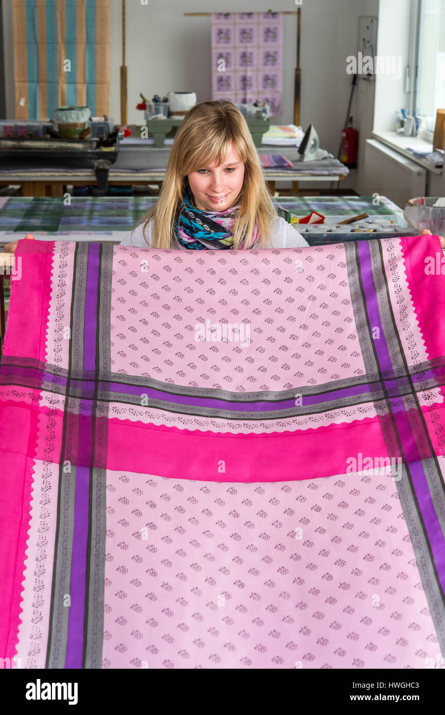 Block printing, woman holding finished panel, finished fabrics at back, Bad Aussee, Styria, Austria Stock Photo