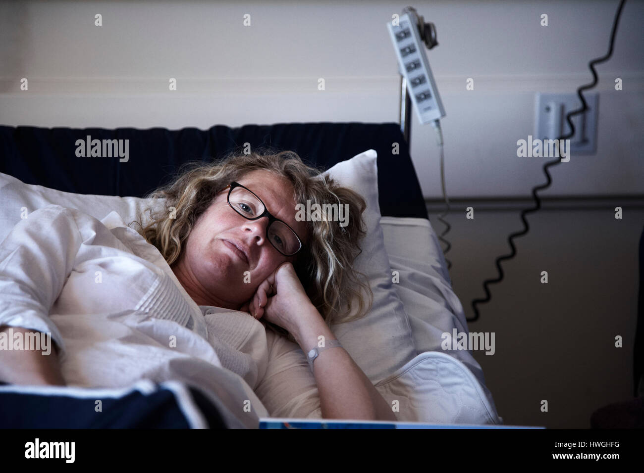 woman lying in hospital bed Stock Photo