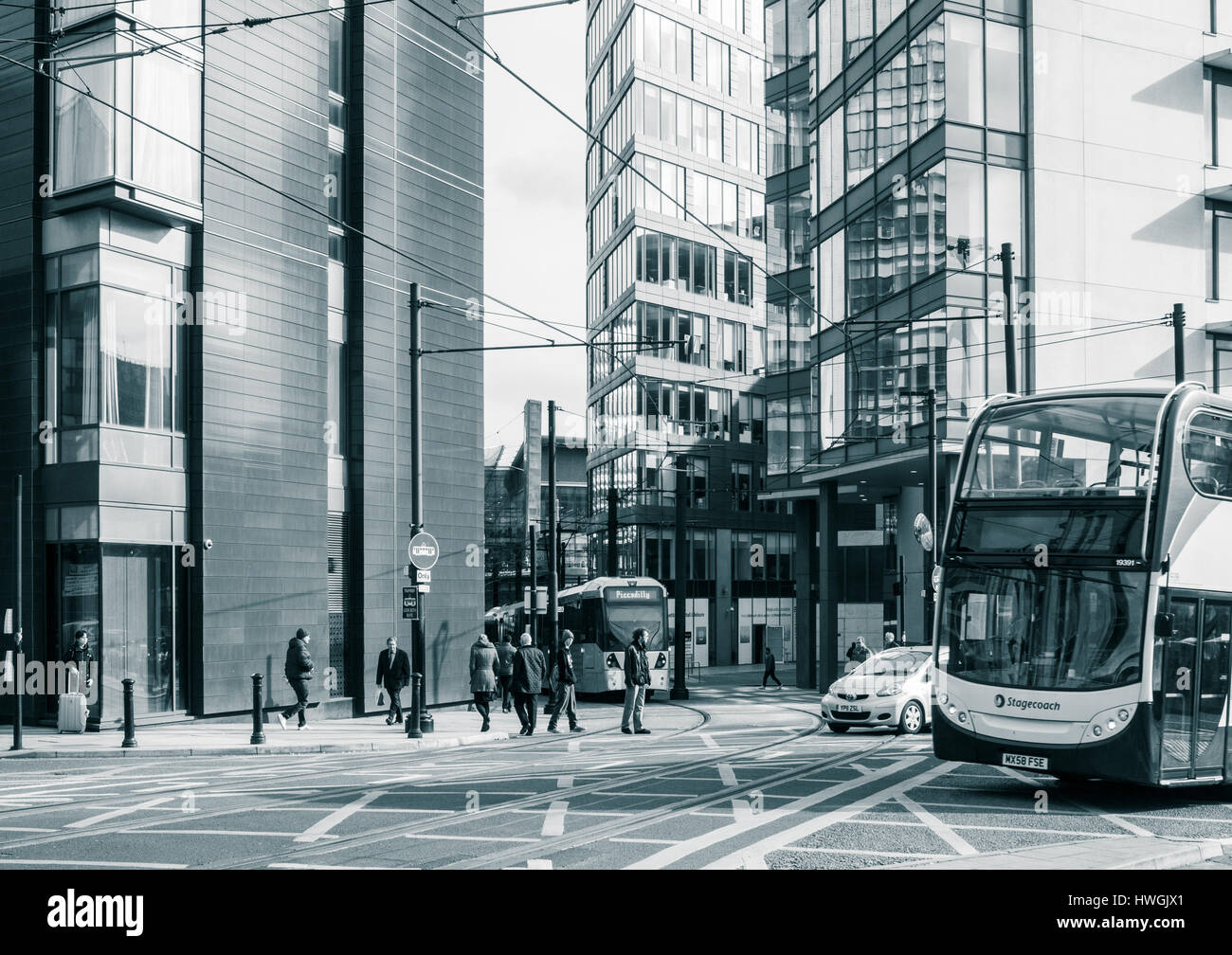 Bus and Tram passing One Piccadilly Place, 1 Auburn Street., Manchester, United Kingdom Stock Photo