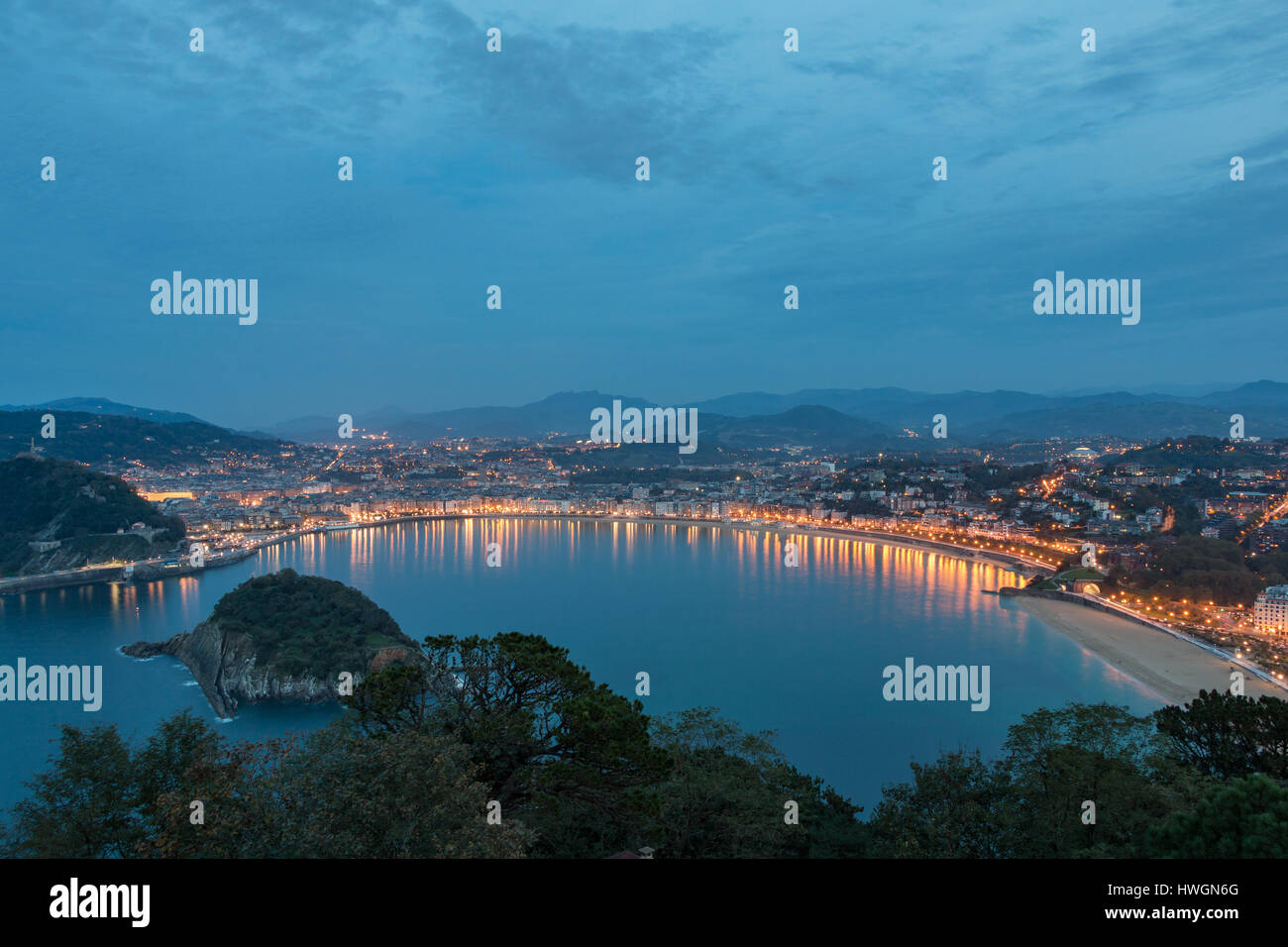 Looking over Bahía de La Concha with San Sebastian / Donostia, Spain behind it Stock Photo