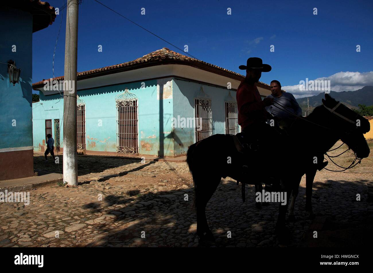 Cuba, province of Sancti Spiritus, Trinidad de Cuba, World heritage of UNESCO, shadow of a cavalier with hat in front of colonial colourful houses Stock Photo
