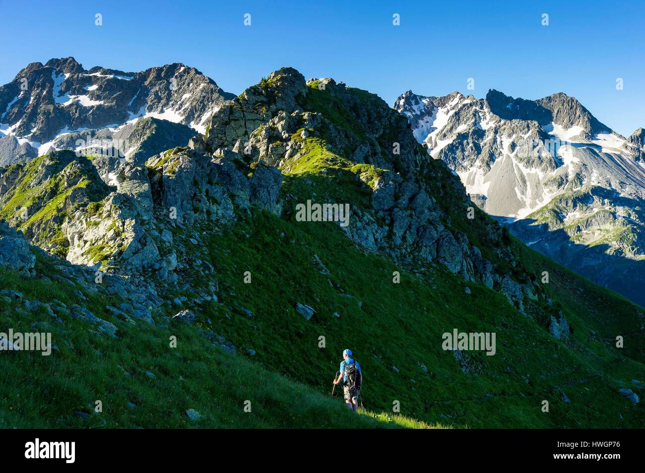 France, Savoie, Arvillard, Hiker walking between the Col d'Arpingon (2276m) and Refuge des Ferices (1920m) Stock Photo