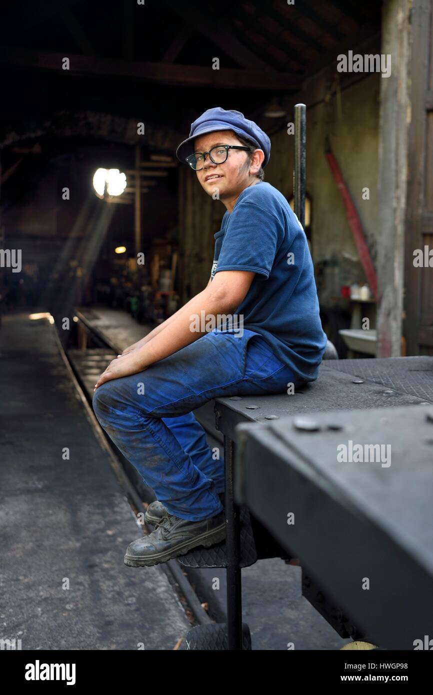 France, Alpes Maritimes, Puget Theniers, steam engine warming up, Benoit Prudhomme-Lacroix Lacroix is one of the youngest volunteers of the G.E.C.P. that restores and operates the Train des Pignes, outside the maintenance workshop at the motive power depot Stock Photo