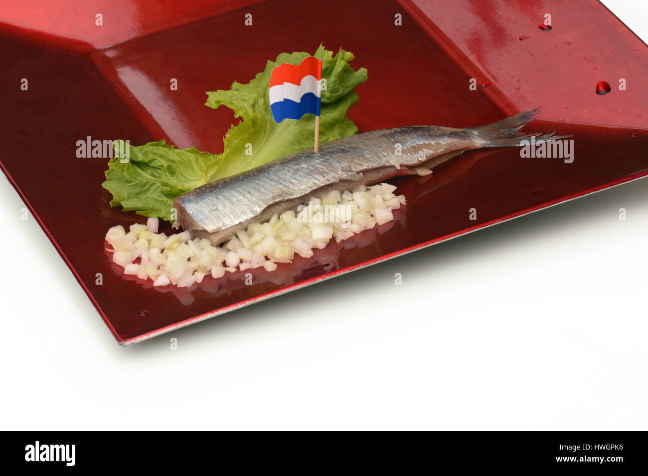 Herring on plate with chopped onions and Dutch flags Stock Photo