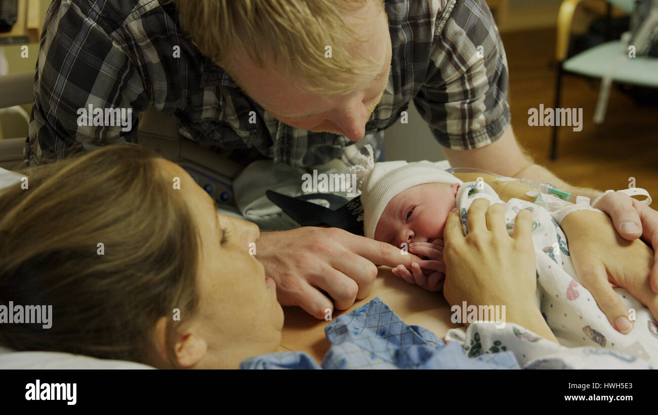 High angle view of new mother and father admiring newborn baby in hospital Stock Photo