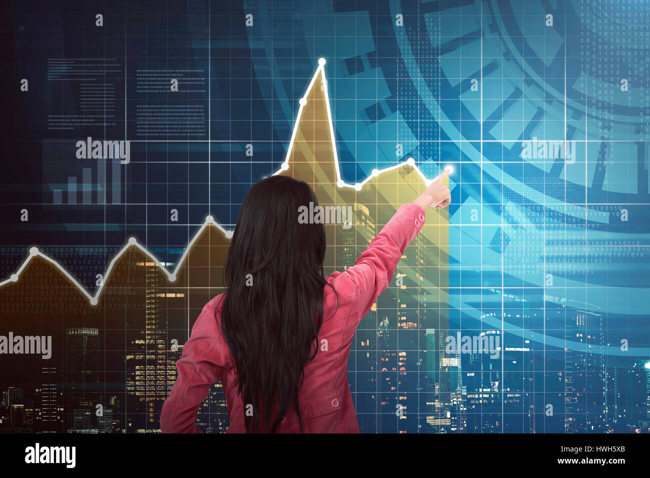 Back view of asian business woman pointing chart on digital screen ...