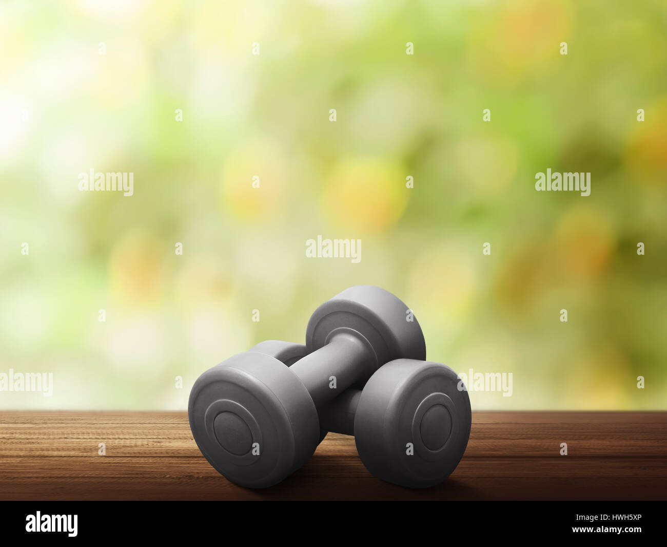 Red dumbbells for weight training on wooden table Stock Photo