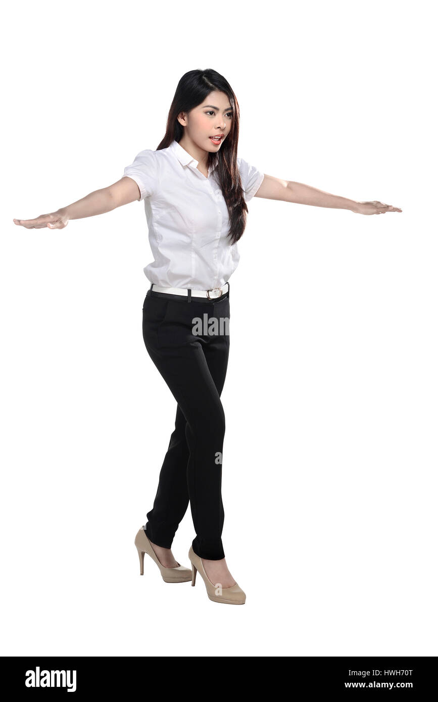 Full body asian business woman walking carefully, try to balance himself, isolated on white background Stock Photo