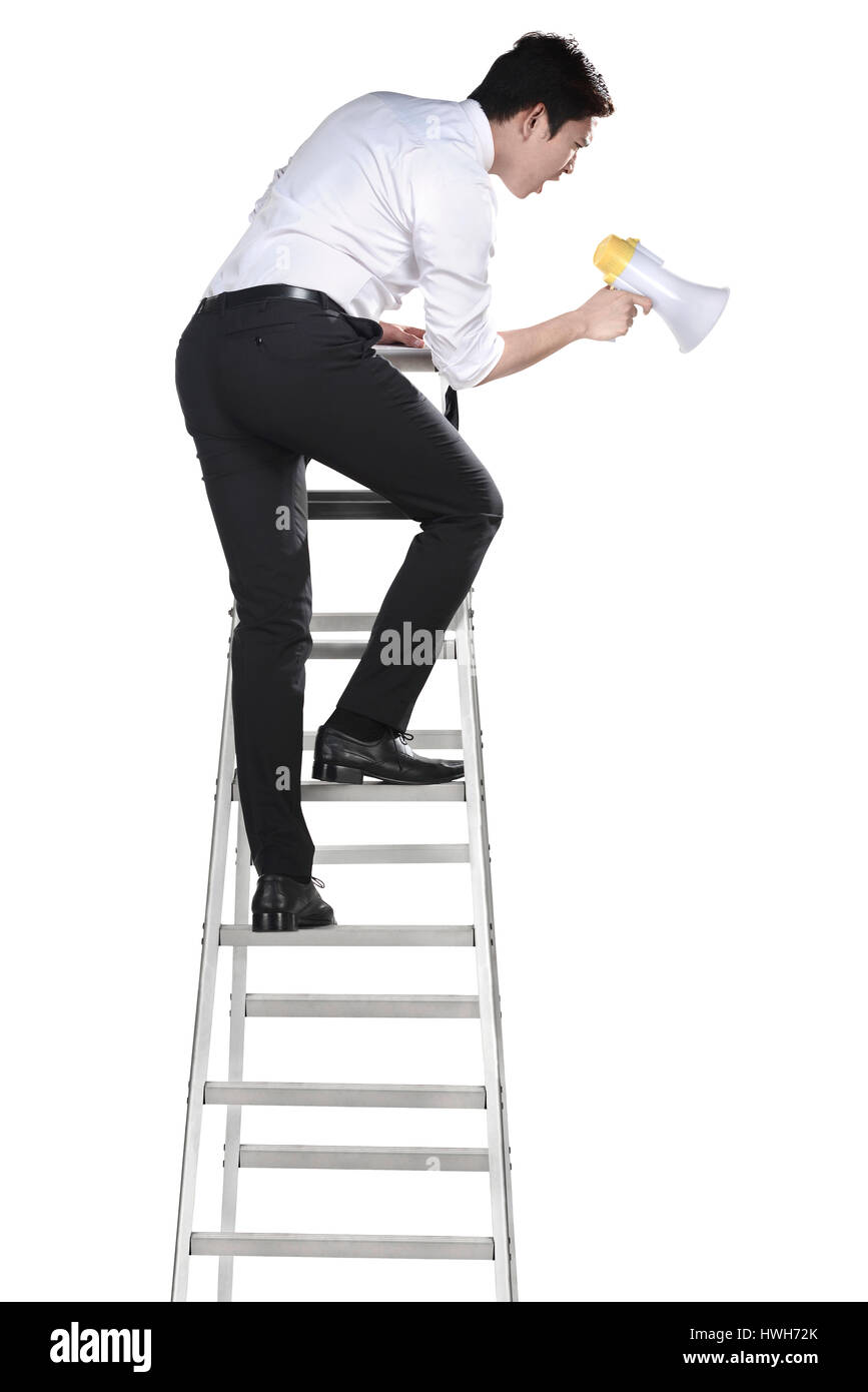 Asian man holding megaphone on the ladder isolated over white background Stock Photo