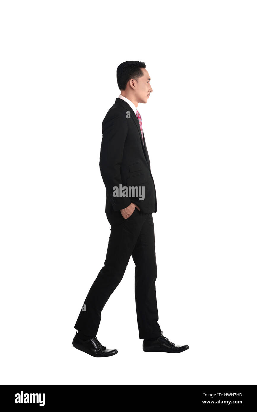 Asian business man walking isolated over white background Stock Photo