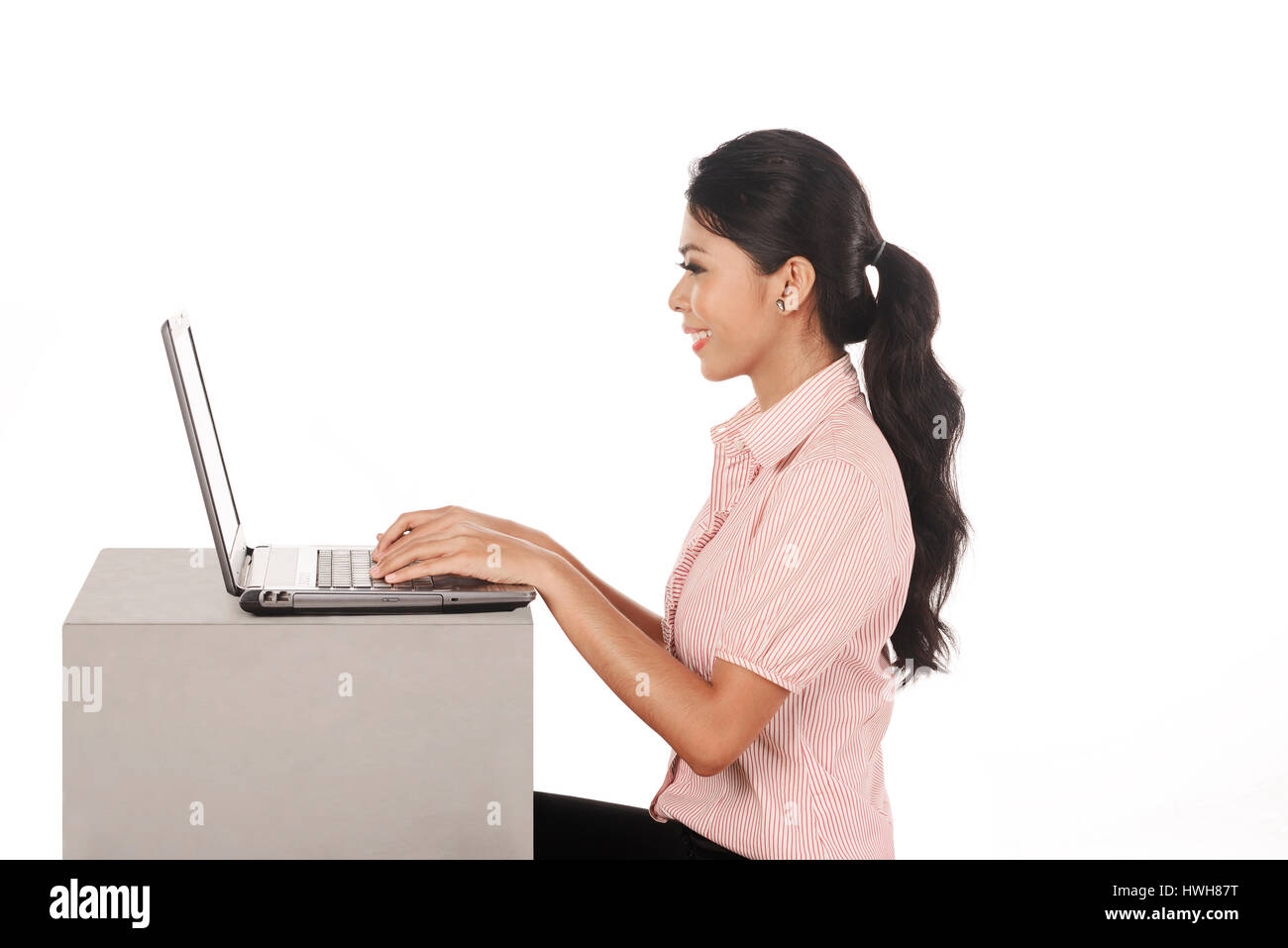 Business woman working on laptop isolated over white background Stock Photo