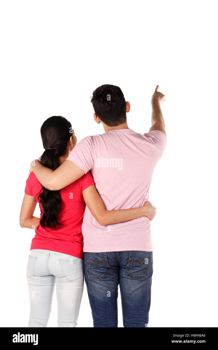 Young asian couple pointing something isolated over white background Stock Photo