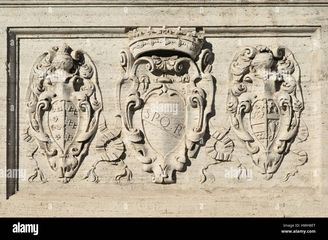 SPQR symbol of Ancient Roman Republic with other old noble emblems on Capitol Hill monumental staircase in Rome Stock Photo