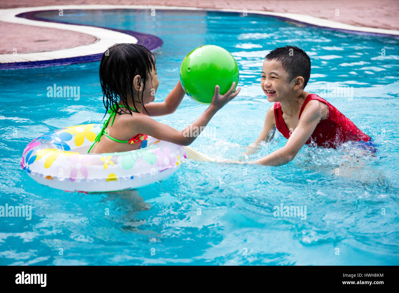 Asian Chinese Little Kids Playing in the outdoor Swimming Pool Stock