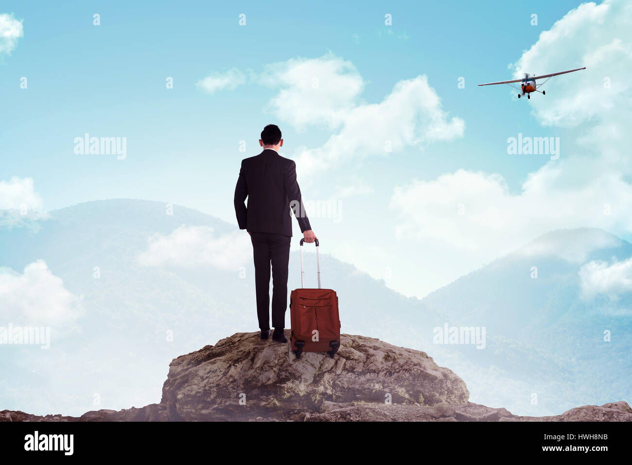 Business man standing on the top of the mountain. Business travel ...
