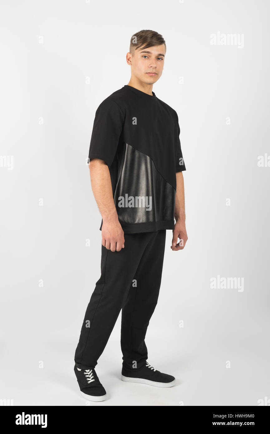 Young muscular man wearing black clothes and sneakers isolated on white background Stock Photo