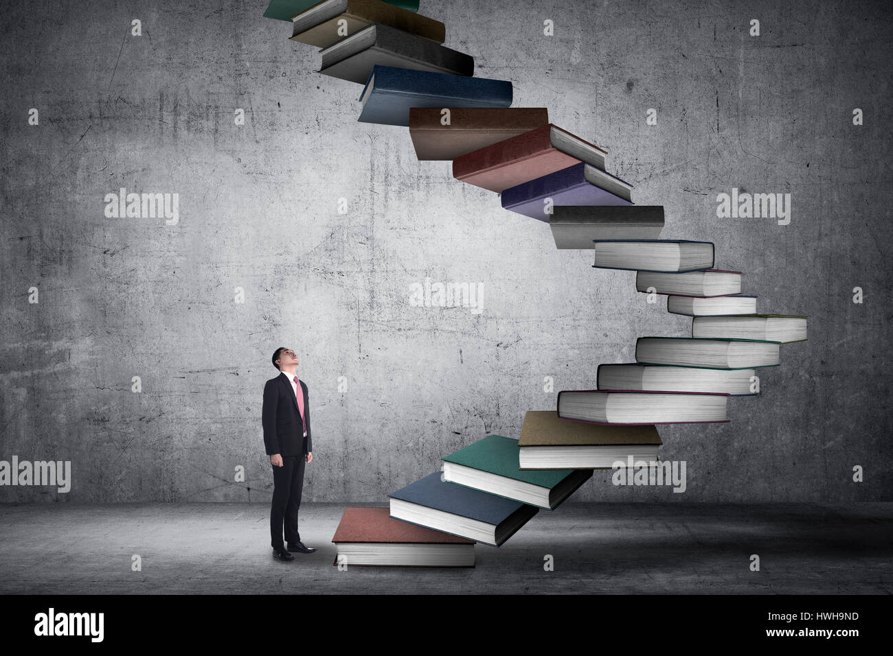 Business person step up flying book that look like stair. Career and education concept Stock Photo