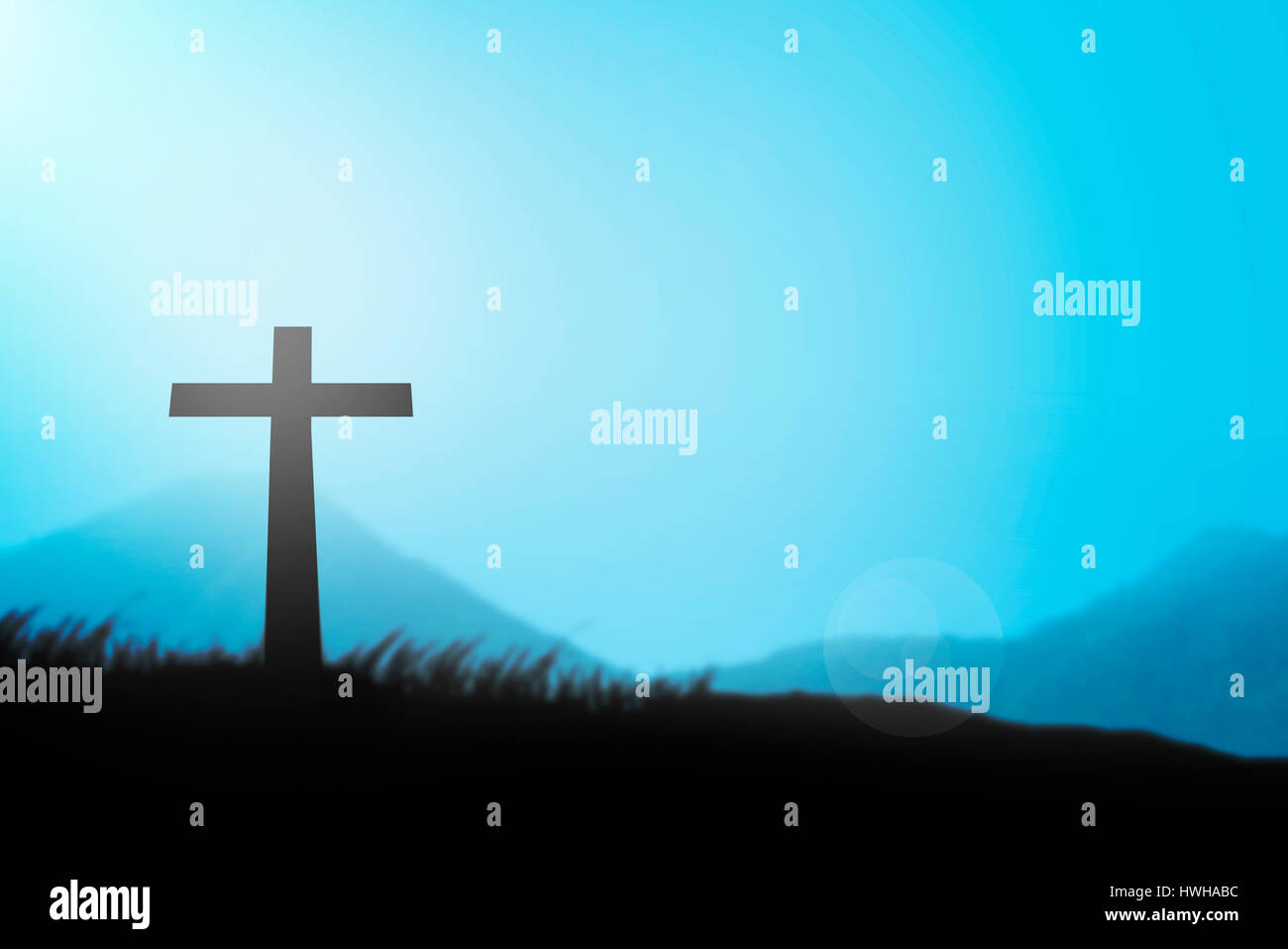 Christian cross with blue sky and haze Stock Photo