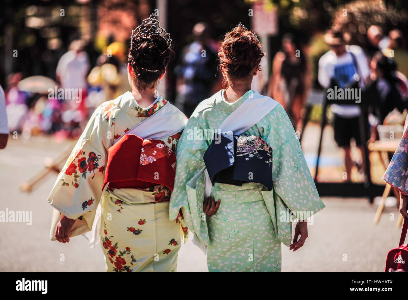 The Back View of Two Japanese Women In The Traditional Clothing Kimono Stock Photo