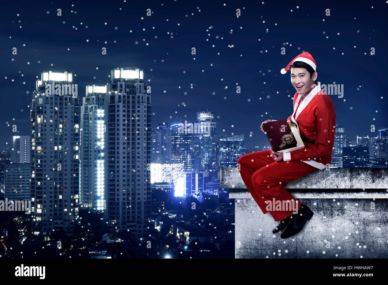 Asian Man Wearing Santa Claus Costume Sit On The Rooftop Christmas