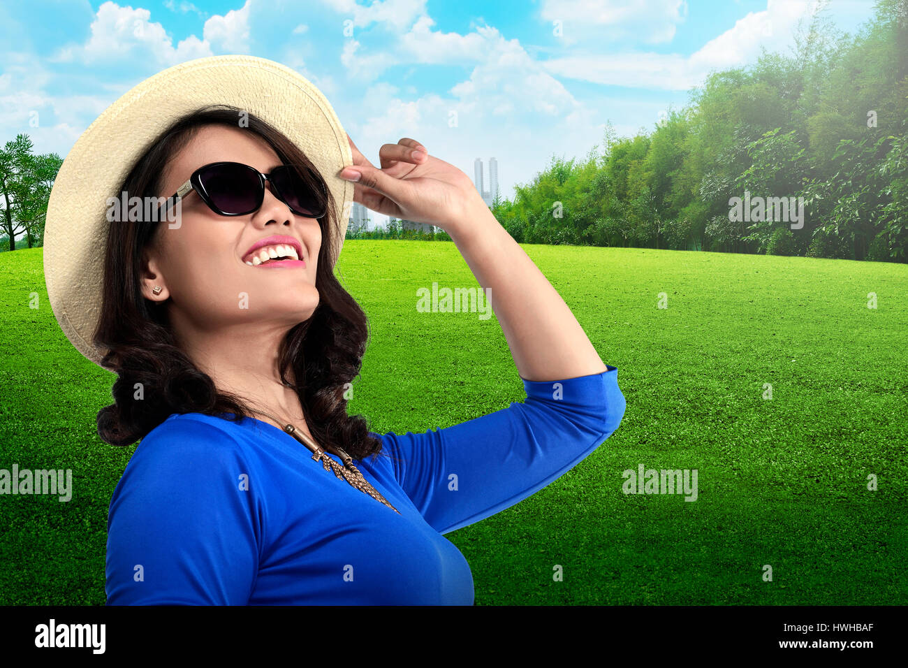 Young asian tourist wearing sunglasses and hat on the city park Stock Photo