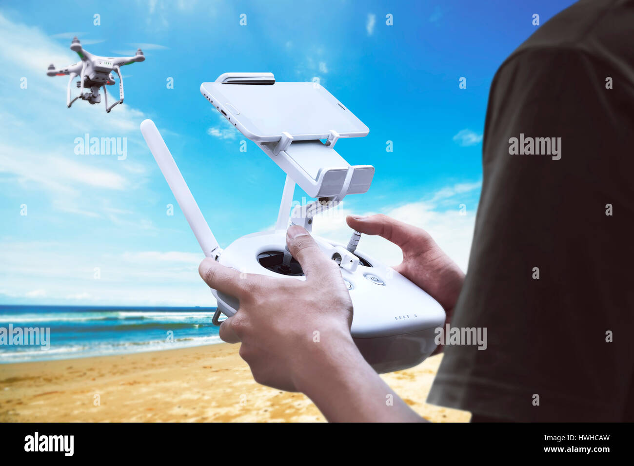 Male pilot controlling drone with remote control Stock Photo