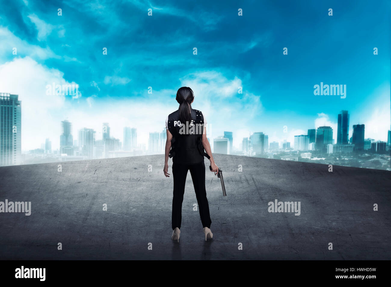 Police woman standing on the building rooftop. Police concept Stock Photo