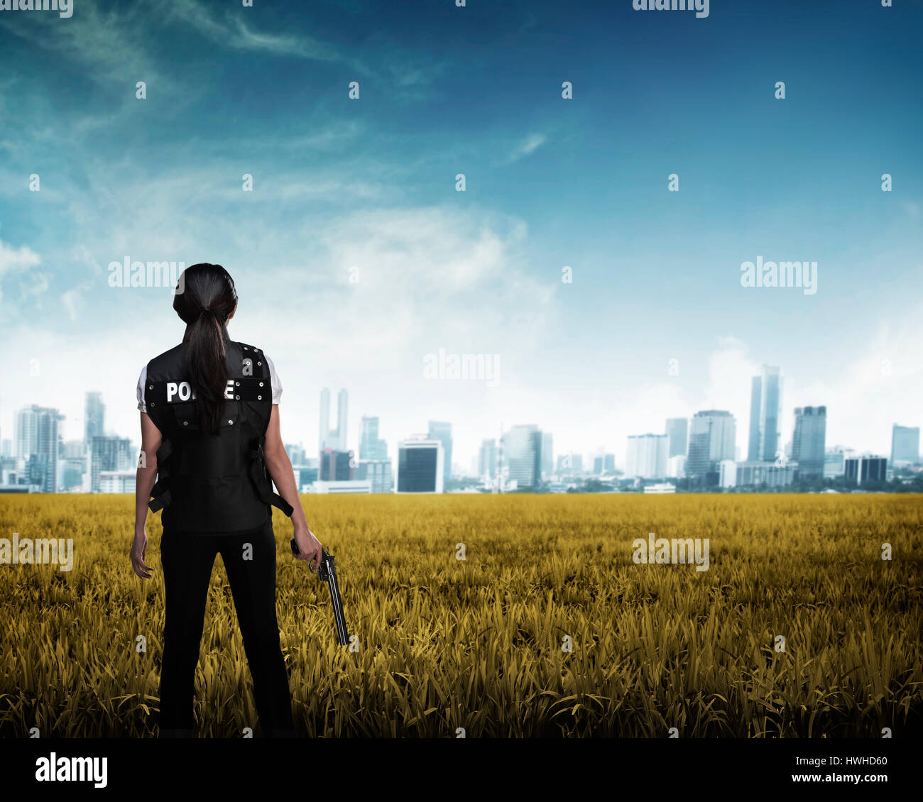 Police woman looking the city in the middle of field. Police concept Stock Photo