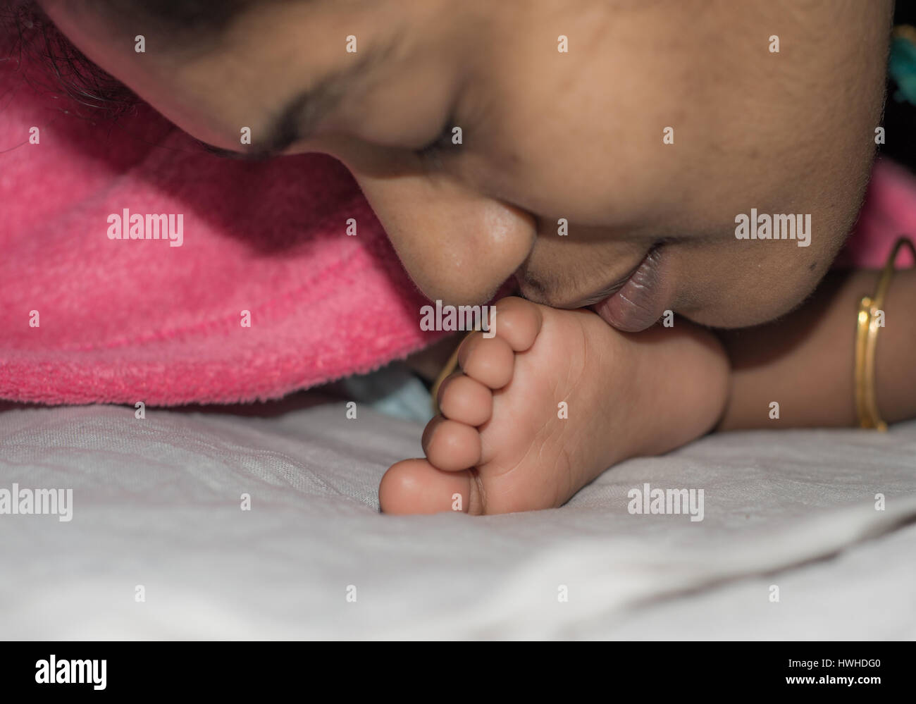 Mother Kissing and Comforting Baby Stock Photo