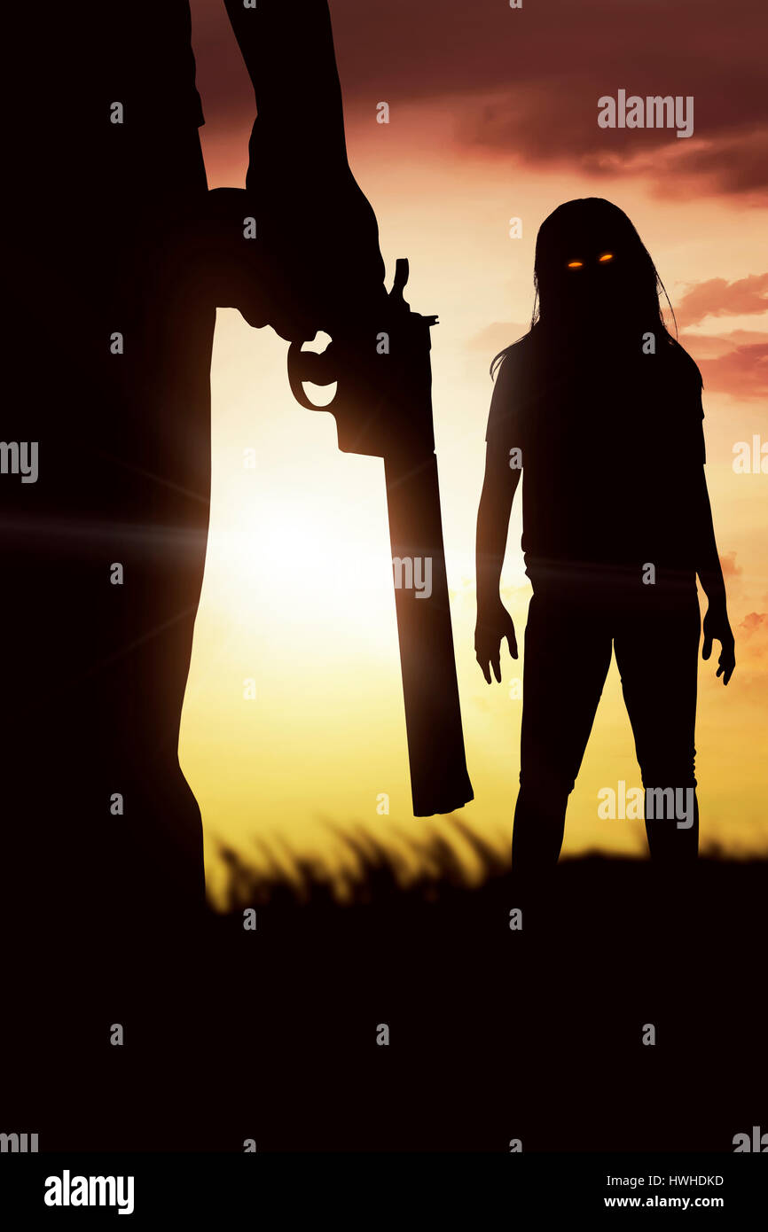 Silhouette of man with the red eye zombie on the sunset Stock Photo