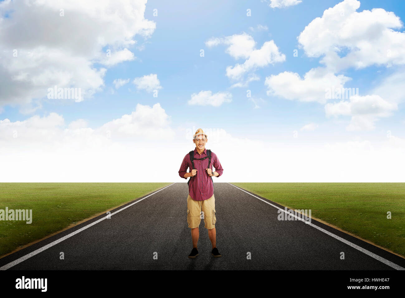 Traveller man with backpack posing on empty road Stock Photo Alamy