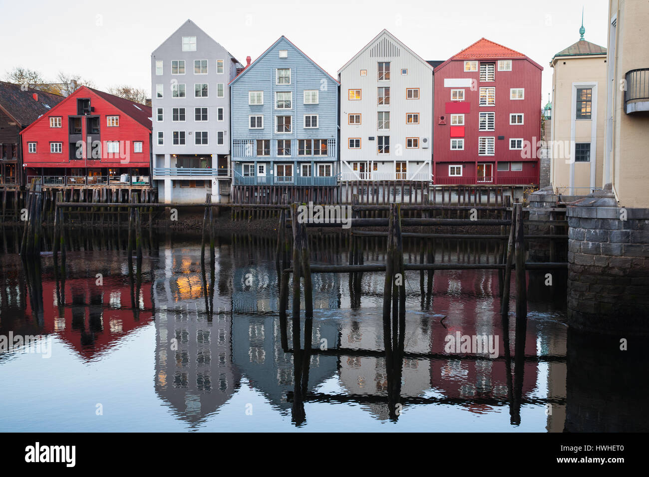 Colorful traditional wooden houses in old town of Trondheim, Norway. Coast of Nidelva river. Cold vintage tonal correction photo filer, old style effe Stock Photo