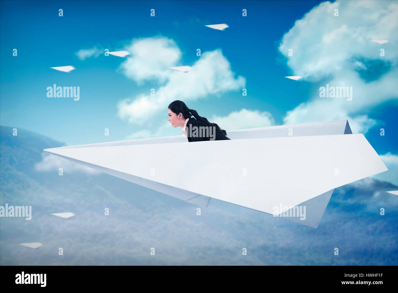 Asian business woman flying with paper plane on the sky Stock Photo - Alamy
