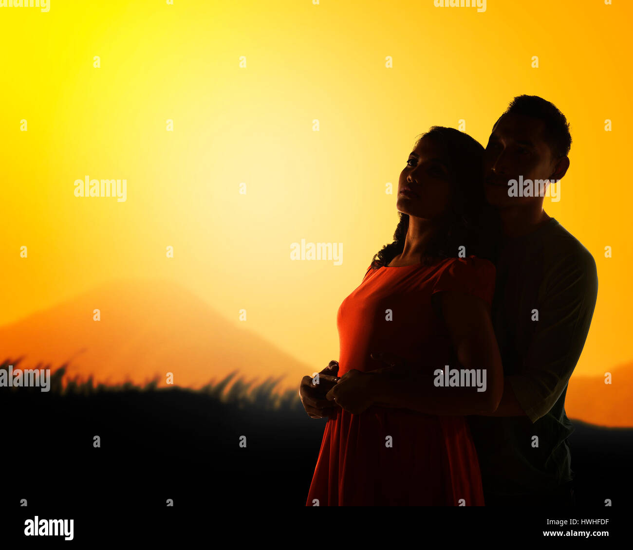 Silhouette of couple when sunset on the mountain Stock Photo - Alamy