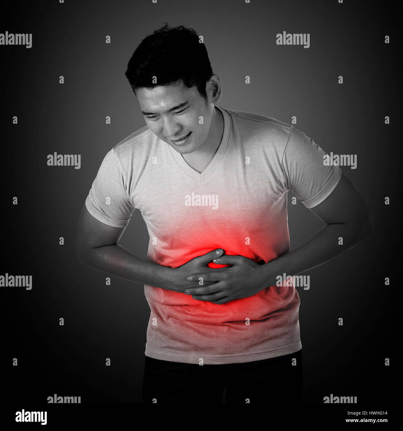 Young asian man have stomach ache, with uneasy face Stock Photo Alamy