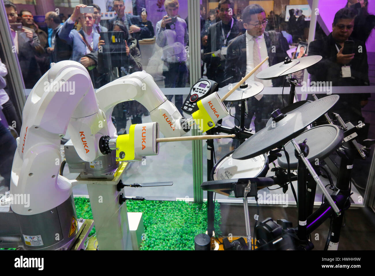 Hannover, Germany, 20th March 2017 - CeBIT digital technology trade fair. Robot arms with drumsticks play on drums on the KUKA robot stand Stock Photo