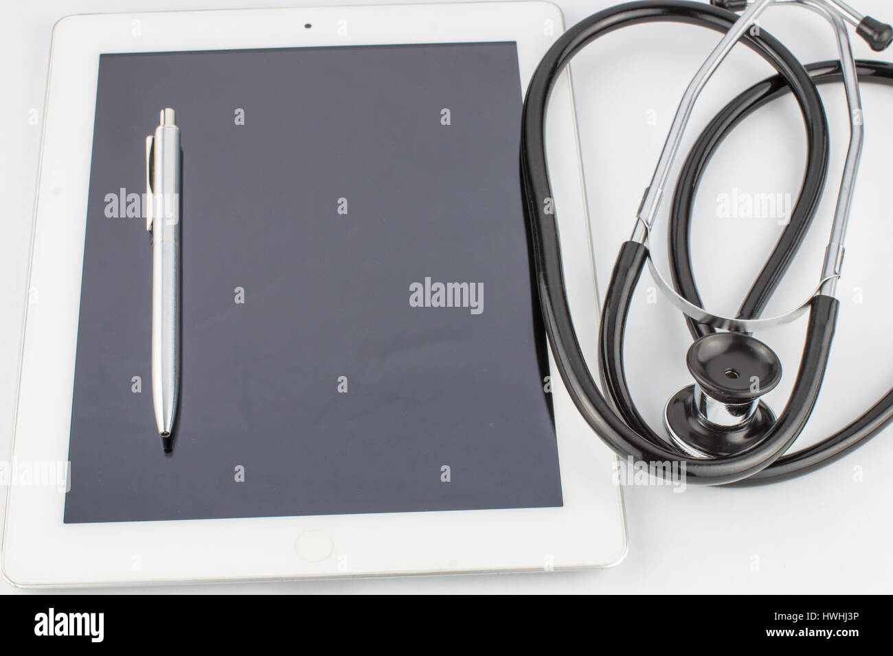 Tablet PC, stethoscope and pen on white background, medical concept ...