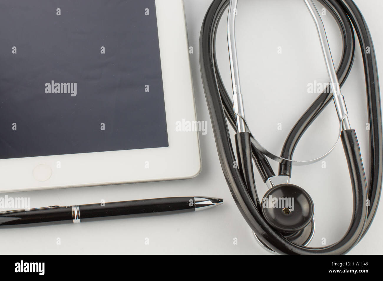 Tablet PC, stethoscope and pen on white background, medical concept ...