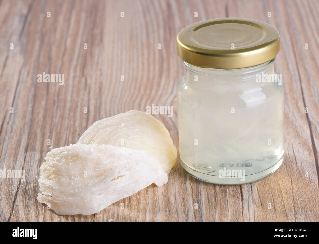 Edible Birdnest in transparent glass bottle on the table, Useing modern technology for processing the products of edible bird's nest. Stock Photo
