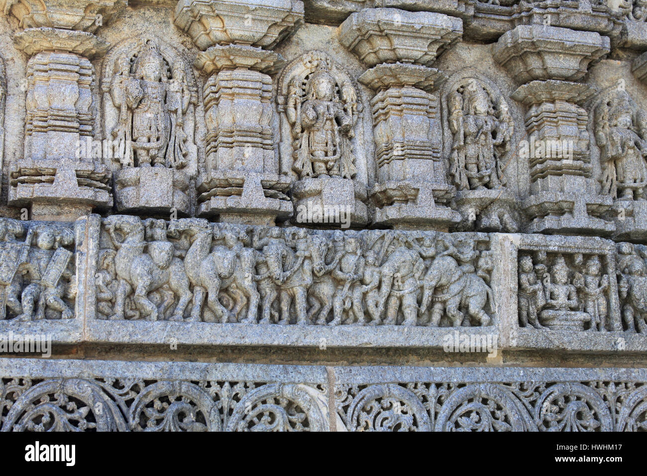 Stone sculptures of deities, panel below depicting stories, Chennakesava Temple, Hoysala Architecture exterior wall, Somnathpur, Karnataka, India Stock Photo