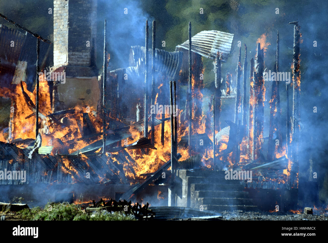 House completely engulfed in flames Stock Photo