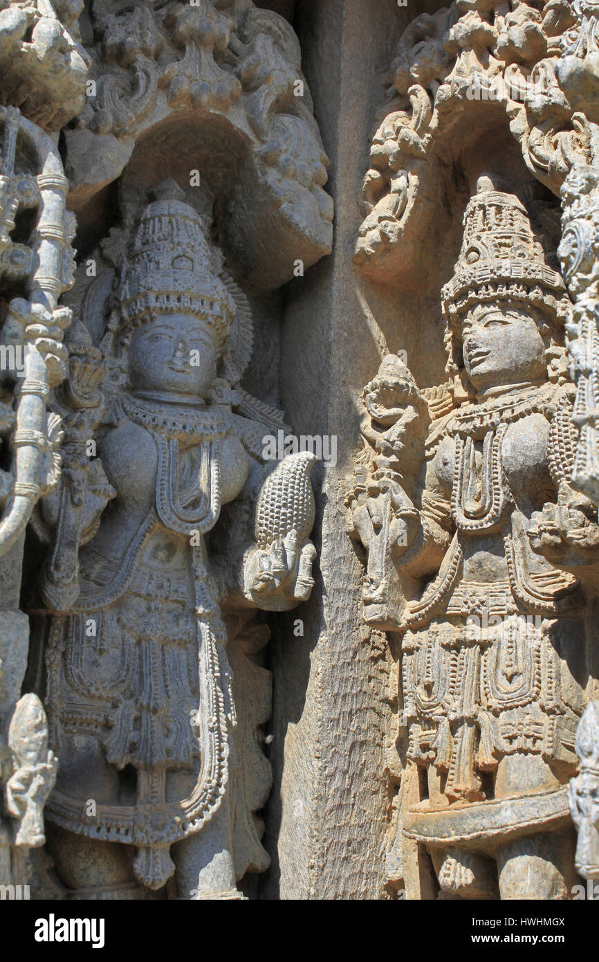 Close up of two deities on two corner wall panel under eves on shrine outer wall in the Chennakesava Temple, Hoysala Architecture at Somnathpur, Karna Stock Photo