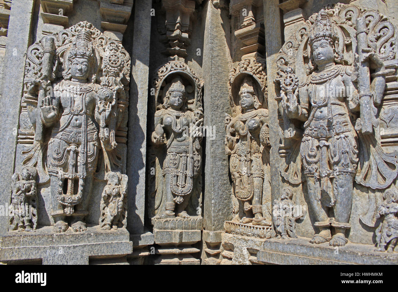 Close up of detailed stone sculpture of Vishnu on the shrine wall damaged by Muhammad Tughlaq’s army at Chennakesava Temple, Hoysala Architecture , So Stock Photo