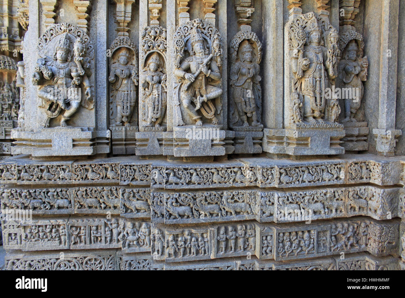 Ornamented detailed, stone carvings on Shrine wall. Relief sculpture depicting gods and goddess, swan, makara(imaginary beast), Hindu puranas, at the  Stock Photo