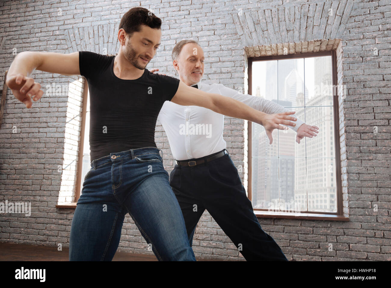 Enjoying our dance lesson. Smiling creative professional dance