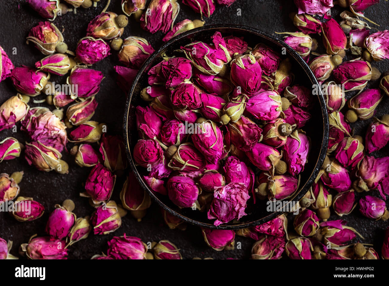 Dried rose buds vie from above Stock Photo