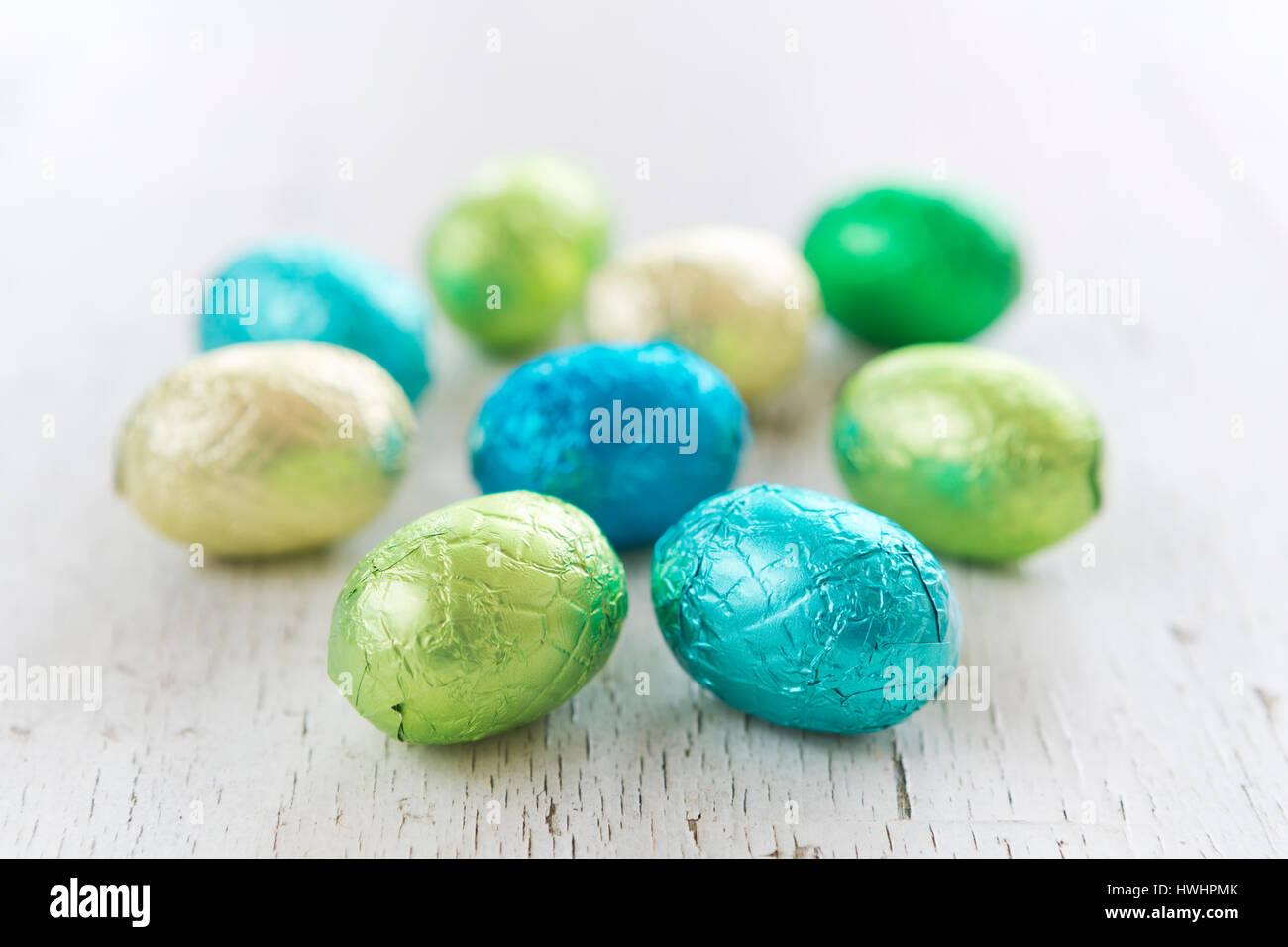 Close up of an assortment of chocolate Easter eggs on a rustic wooden background. Stock Photo