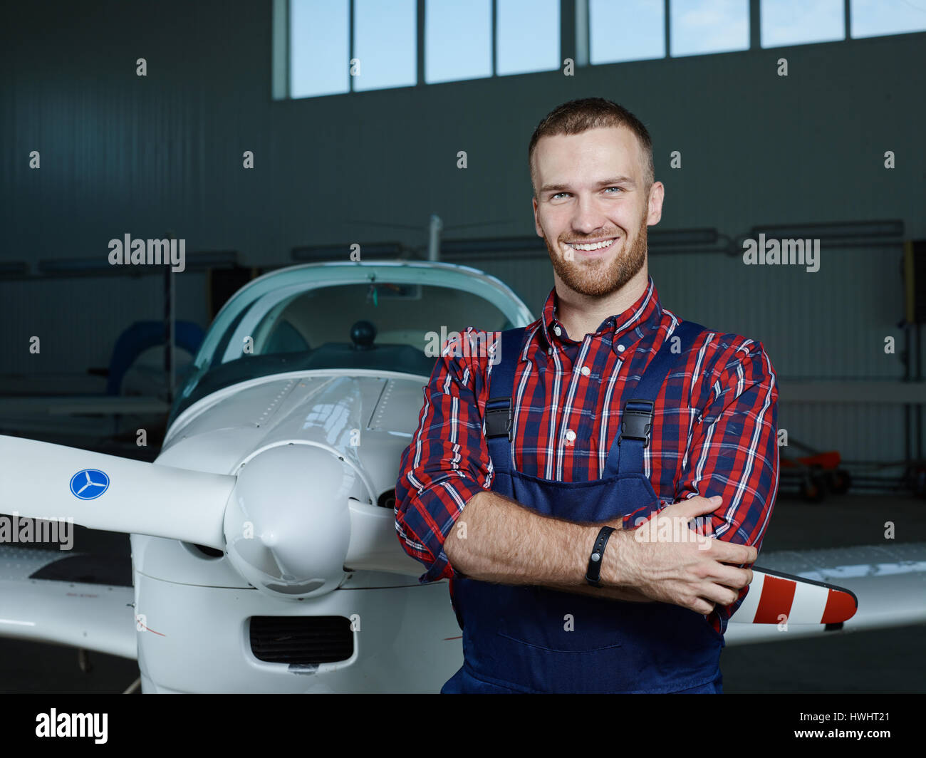 Handsome mechanic in uniform standing 